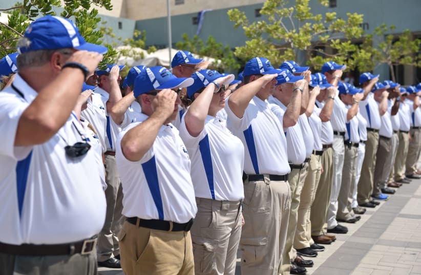 Members of the Police Unity Tour salute their Israeli counterparts at the Beit Shemesh police academy Monday. (photo credit: POLICE SPOKESPERSON'S UNIT)