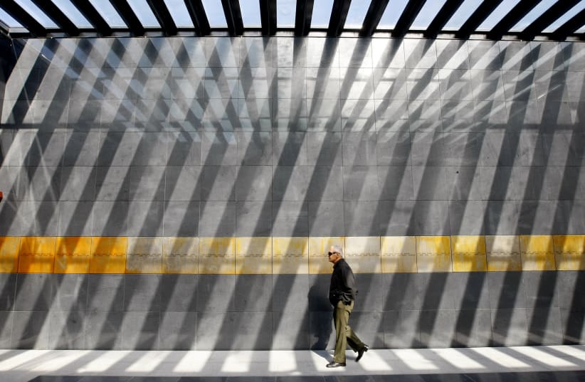 A man visits the entrance of the Holocaust memorial in Bucharest, Romania (photo credit: REUTERS/BOGDAN CRISTEL)
