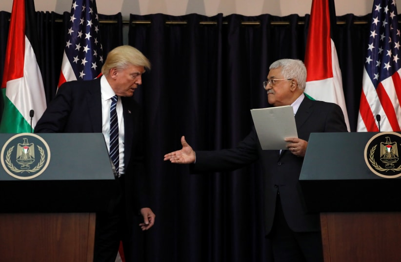 Palestinian President Mahmoud Abbas extends his hand to US President Donald Trump at the Presidential Palace in the West Bank city of Bethlehem May 23, 2017. (photo credit: REUTERS)