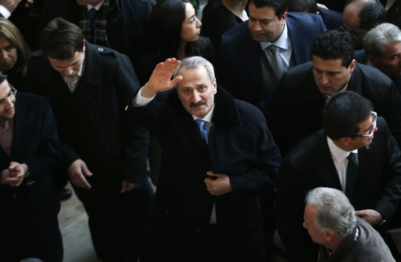 Turkey's former Economy Minister Zafer Caglayan waves as he arrives at a handover ceremony in Ankara  (photo credit: UMIT BEKTAS / REUTERS)