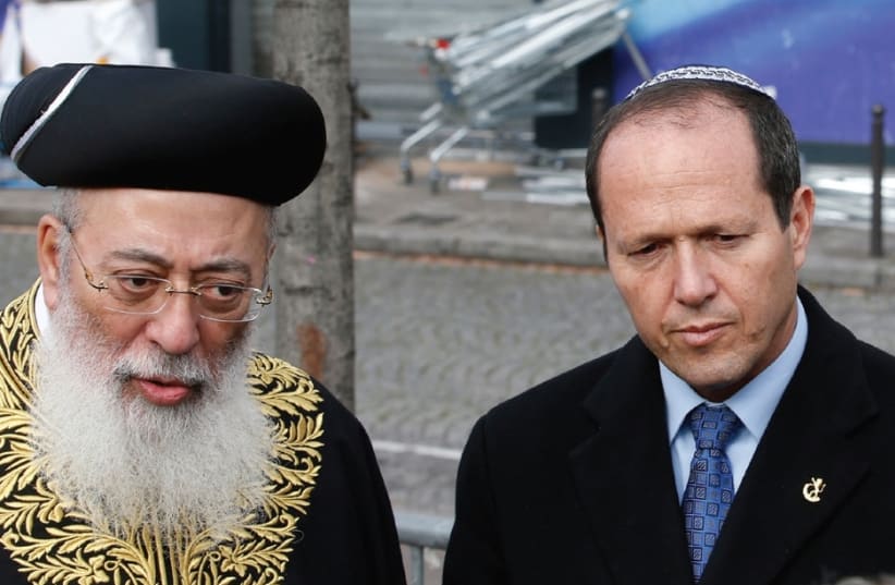 Shlomo Amar, at the time Sephardi chief rabbi of Israel, attends a memorial ceremony at the Hyper Casher kosher supemarket in Paris together with Jerusalem Mayor Nir Barkat in January 2015. (photo credit: REUTERS)