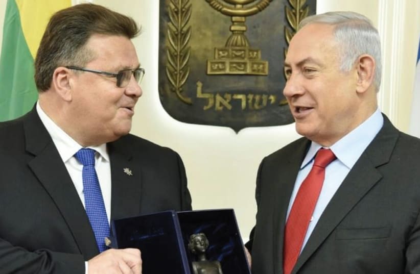 LITHUANIAN FOREIGN MINISTER Linas Linkevicius presents Prime Minister Benjamin Netanyahu with a replica of a little girl from a Holocaust memorial in Lithuania during their meeting in Jerusalem on Monday. (photo credit: LITHUANIAN EMBASSY ISRAEL)
