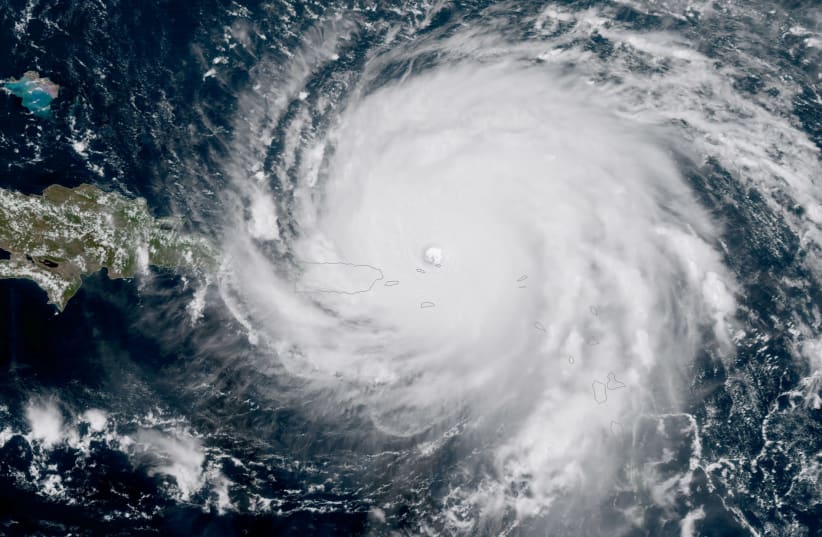 Hurricane Irma, a record Category 5 storm, is seen approaching Puerto Rico in this NASA's GOES-16 satellite image taken at about 15:15 EDT on September 6, 2017. (photo credit: COURTESY NOAA NATIONAL WEATHER SERVICE NATIONAL HURRICANE CENTER/HANDOUT VIA REUTERS)