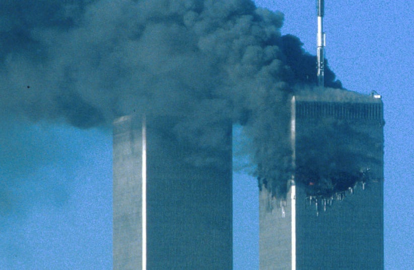 The twin towers after being hit, 9/11 (photo credit: SEAN ADAIR/ REUTERS)