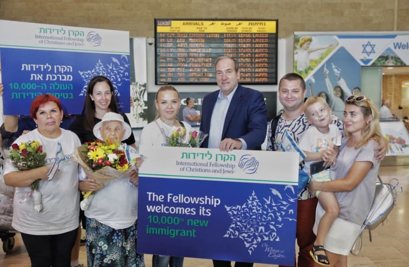  IFCJ Founder Yechiel Eckstein poses with the Pokutnia family at Ben-Gurion Airport last week. (photo credit: OLIVIA FITUSSI)