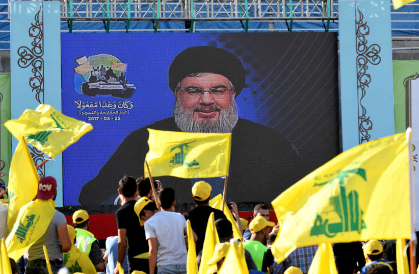 Hezbollah leader Sayyed Hassan Nasrallah speaks to supporters on a screen (photo credit: HASSAN ABDALLAH / REUTERS)