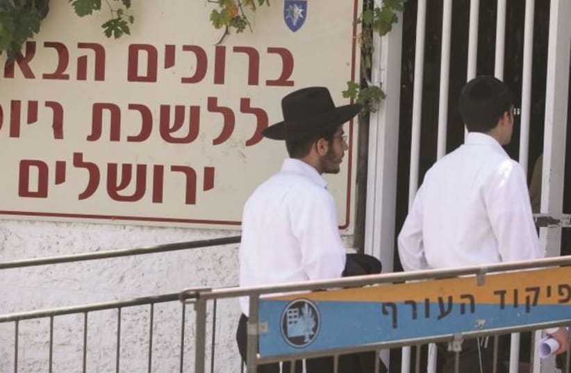 Haredi men at the IDF conscription base in Tel Aviv (photo credit: MARC ISRAEL SELLEM/THE JERUSALEM POST)