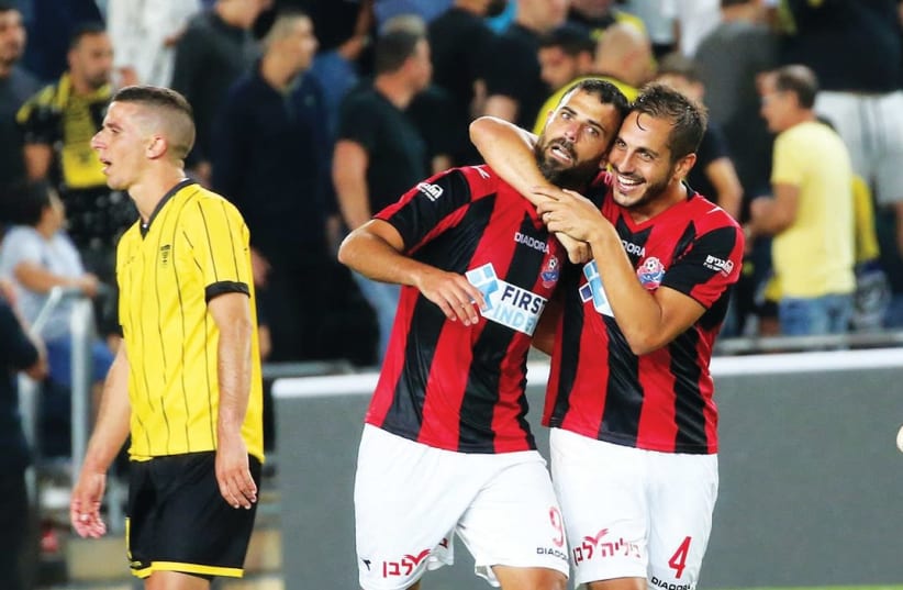 Hapoel Haifa striker Eden Ben-Basat (center) celebrates with teammate Dor Malul. (photo credit: UDI ZITIAT)