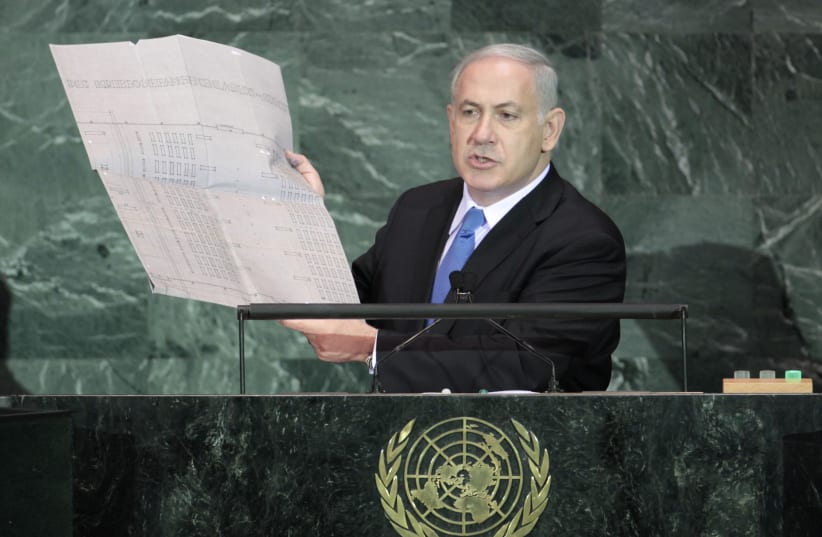 Israeli Prime Minister Benjamin Netanyahu holds up a document outlining plans for the Auschwitz death camp as he addresses the 64th United Nations General Assembly at U.N. headquarters in New York, September 24, 2009.  (photo credit: REUTERS/LUCAS JACKSON)