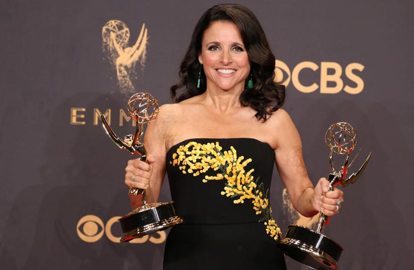 Julia Louis-Dreyfus holds her Emmys for Outstanding Lead Actress in a Comedy Series and Outstanding Comedy Series for Veep (photo credit: LUCY NICHOLSON / REUTERS)