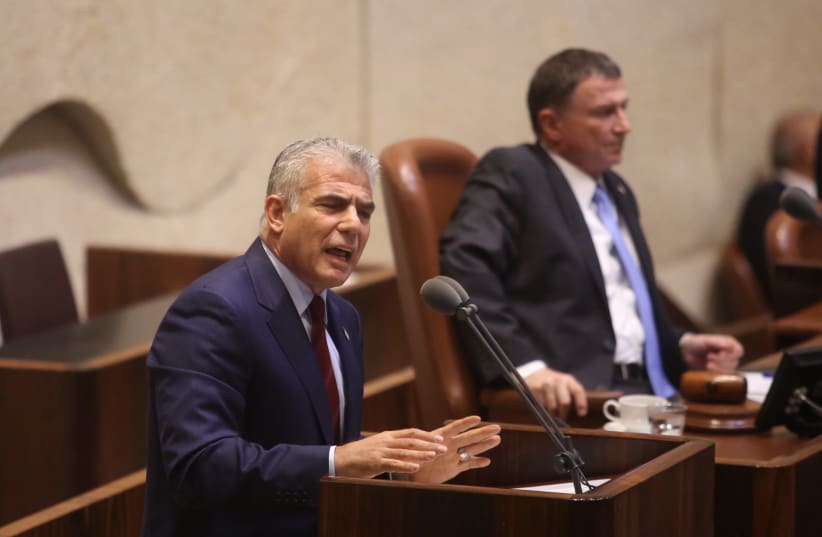 Yesh Atid leader Yair Lapid at the Knesset plenum discussing goverment allowances for the handicap, September 18, 2017. (photo credit: MARC ISRAEL SELLEM/THE JERUSALEM POST)