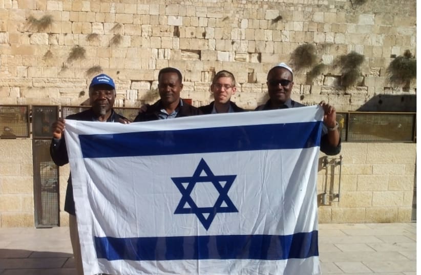 Glick (with visiting Christians at the Western Wall) guards against any perceived offense to the State of Israel or IDF. (photo credit: PR)