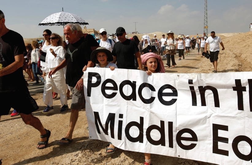 DEMONSTRATORS, INCLUDING Israeli and Palestinian activists, take part in a demonstration in support of peace last year (photo credit: REUTERS)