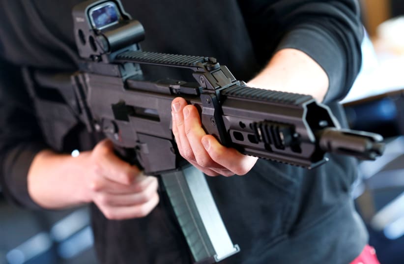 A man holds a G 36 KA rifle manufactured by Heckler & Koch (photo credit: REUTERS/RALPH ORLOWSKI)