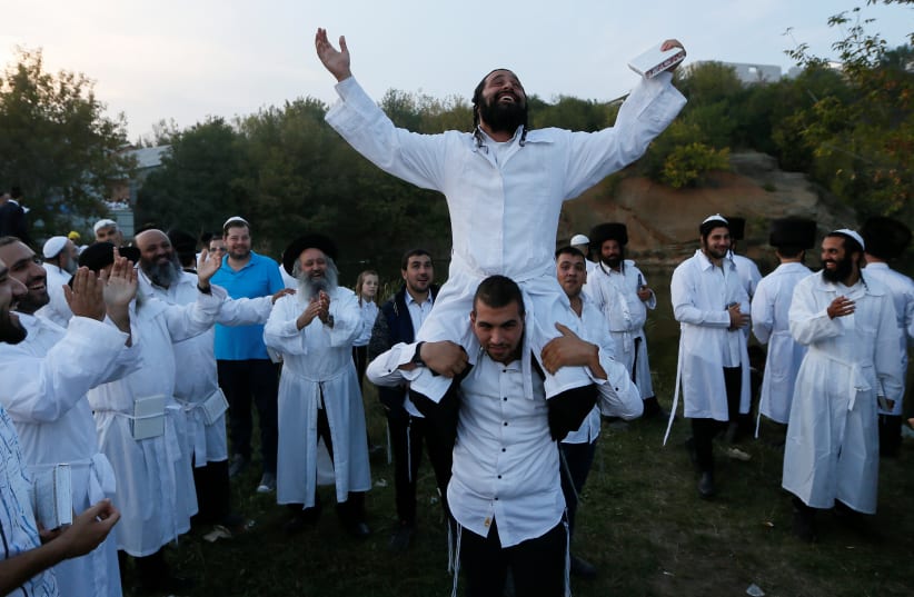 Ultra-Orthodox Jewish pilgrims celebrate the Rosh Hashana holiday, the Jewish New Year, near the tomb of Rabbi Nachman of Breslov in Uman, Ukraine, September 21, 2017. (photo credit: REUTERS)