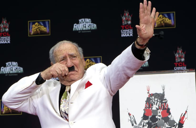 Filmmaker and comedian Mel Brooks gestures as he places his footprints in cement, with a fake sixth finger attached to his left hand, in the forecourt of the TCL Chinese theatre in Hollywood, California September 8, 2014. (photo credit: MARIO ANZUONI/REUTERS)