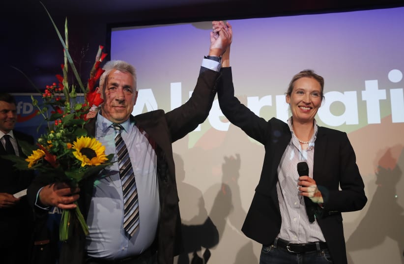 Alice Weidel (R), top candidate of the anti-immigration party Alternative fuer Deutschland (AfD) reacts after first exit polls in the German general election (Bundestagswahl) in Berlin, Germany, September 24, 2017.  (photo credit: WOLFGANG RATTAY / REUTERS)