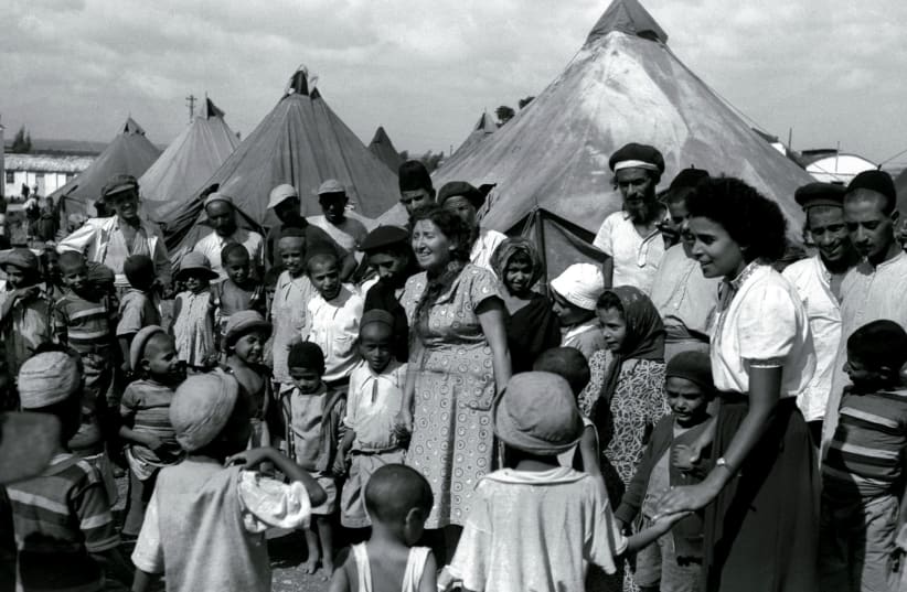 Jewish immigrants from Yemen in a tent encampment in 1949 as they are visited by Israeli nurses. (photo credit: REUTERS)
