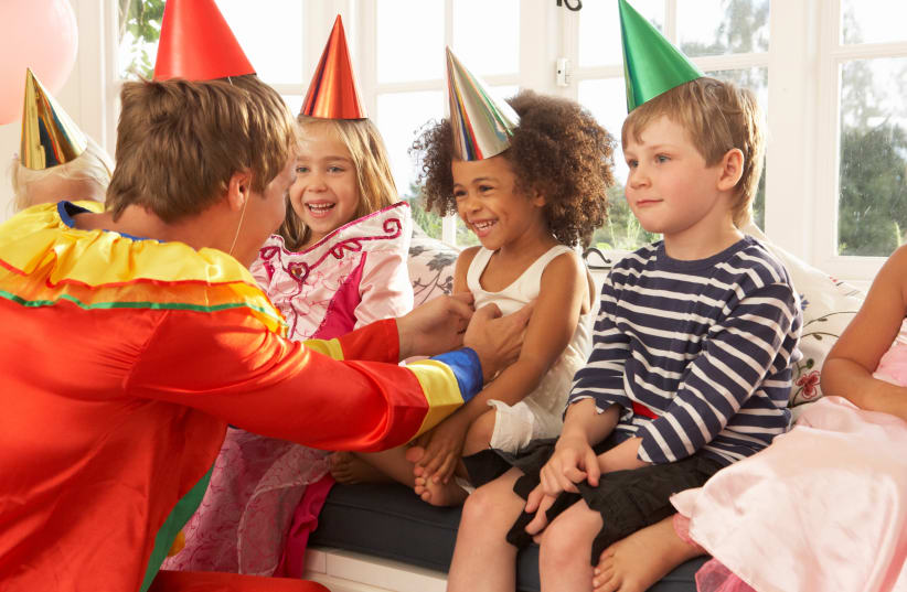clown entertaining children at a party (photo credit: INGIMAGE)