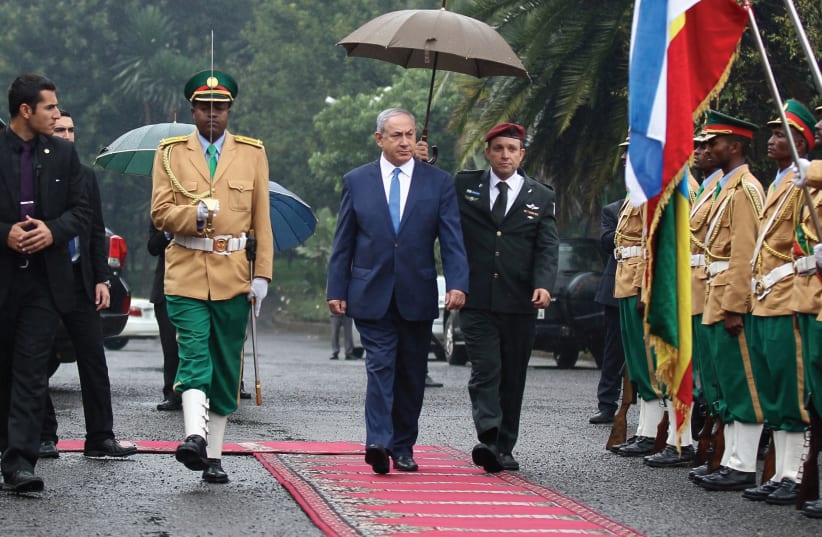 PRIME MINISTER Benjamin Netanyahu inspects a guard of honor at the National Palace during his state visit to Addis Ababa, Ethiopia, last July. (photo credit: REUTERS)