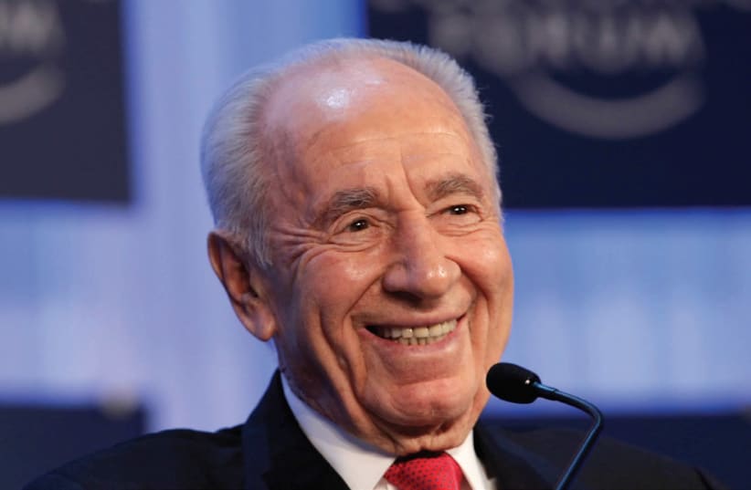 SHIMON PERES smiles during the annual meeting of the World Economic Forum (WEF) in Davos in 2013. (photo credit: REUTERS)