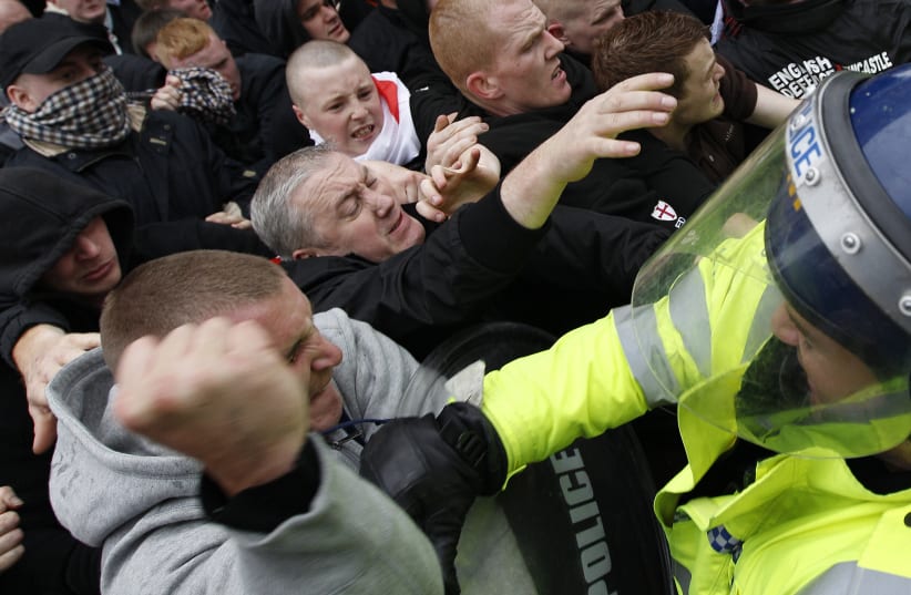 Far-right demonstrators clash with police officers during a march in Leicester, central England, October 9, 2010. (photo credit: REUTERS)