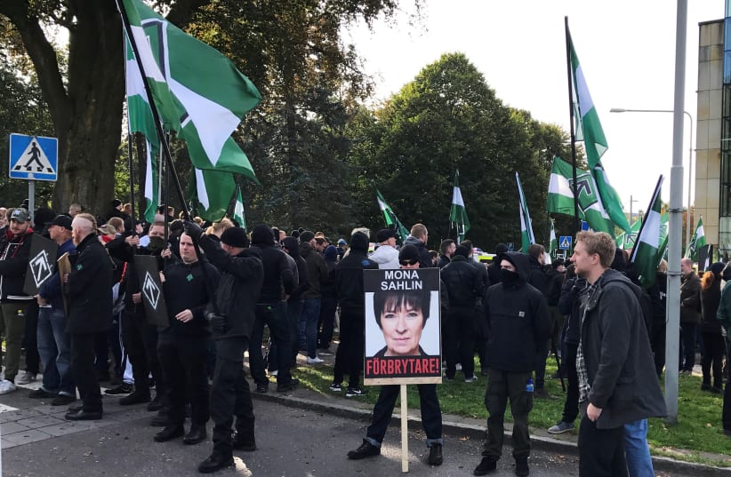 Members of the Nordic Resistance Movement gather before a demonstration in Gothenburg, Sweden September 30, 2017. Placard reads "Mona Sahlin is a criminal!" (photo credit: JOHAN AHLANDER/REUTERS)
