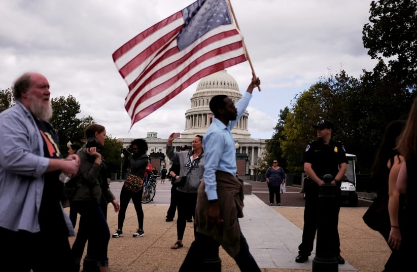 Protesters with the March for Racial Justice calling for racial equity and justice pass by the US Capitol in Washington. (photo credit: REUTERS)
