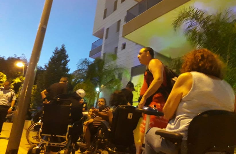 Disabled protesters in front of the home of David Bitan   (photo credit: YUVAL BAGNO)