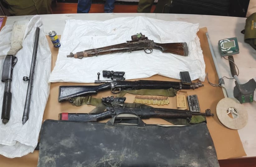 WEAPONS seized during overnight raids in the West Bank village of Bani Naim are displayed by the Israel Police. (photo credit: ISRAEL POLICE)