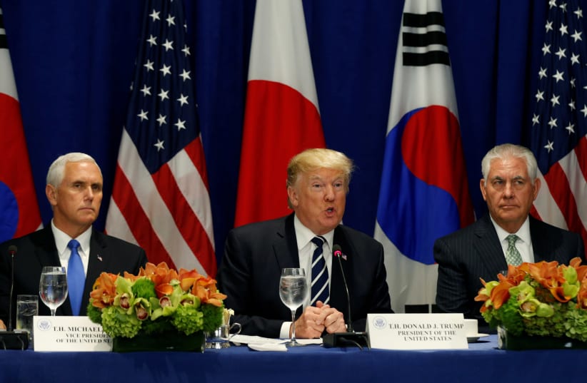 US President Donald Trump, flanked by Vice President Mike Pence and Secretary of State Rex Tillerson, speaks during a meeting with South Korean president Moon Jae-in and Japanese Prime Minister Shinzo Abe during the UN General Assembly in New York, US, September 21, 2017. (photo credit: KEVIN LAMARQUE/REUTERS)