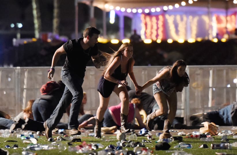People run from the Route 91 Harvest country music festival after gun fire was heard (photo credit: DAVID BECKER/GETTY IMAGES/AFP)