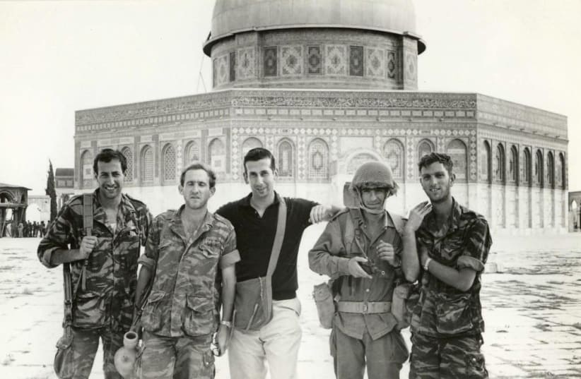 MOSHE GOLDENHIRSCH THE AUTHOR, Abraham Rabinovich, poses for a photo with IDF soldiers atop the Temple Mount in June 1967 shortly after the war’s end.a circus and then goes undercover in Nazi Berlin, as the Iranian mentalist Zabbatini. (photo credit: Courtesy)