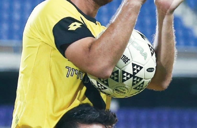 Maccabi Netanya forward Diya Saba received the match ball after scoring a hat-trick in last night’s 4-0 win over Maccabi Petah Tikva in Premier League action (photo credit: REUTERS)