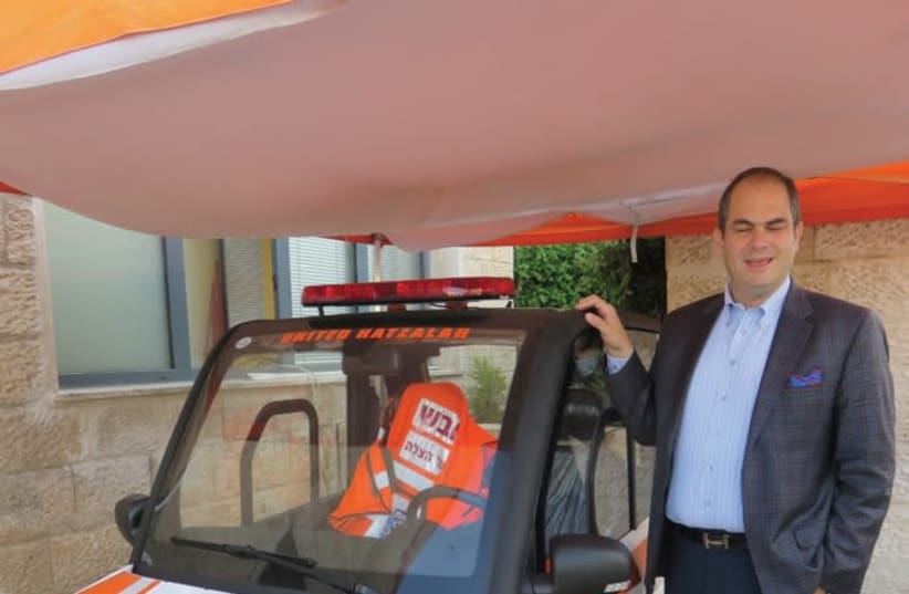 United Hatzalah president and founder Eli Beer stands by a new minilance emergency vehicle. (photo credit: JUDY SIEGEL-ITZKOVICH)
