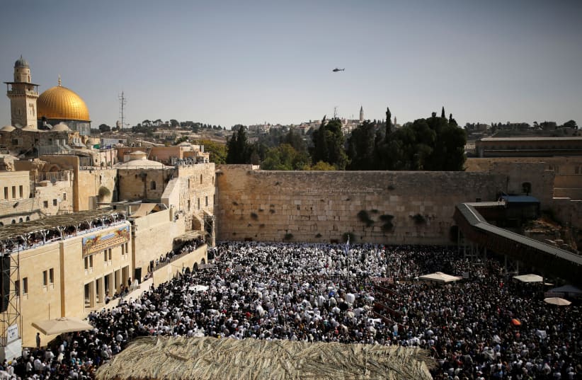 A general view shows Jewish worshippers at the Western Wall, Judaism's holiest prayer site, in Jerusalem's Old City (photo credit: REUTERS/AMIR COHEN)