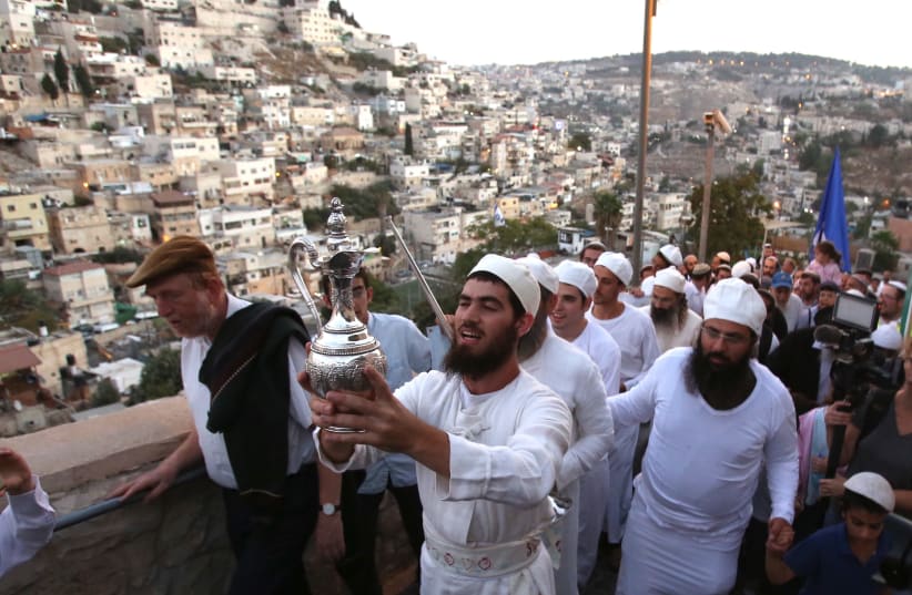 Cohanim holding the water libation instrument during the march in Ir David. (photo credit: MARC ISRAEL SELLEM)