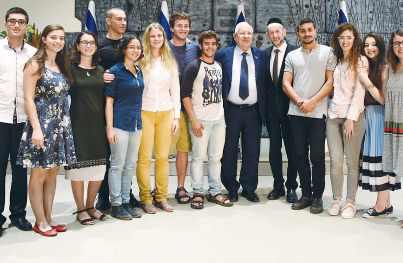 PRESIDENT REUVEN RIVLIN celebrates with the winners of the 2017 Young Scientists and Developers Competition, held annually at Jerusalem’s Bloomfield Science Museum, on March 21 (photo credit: AVI HAYOUN)