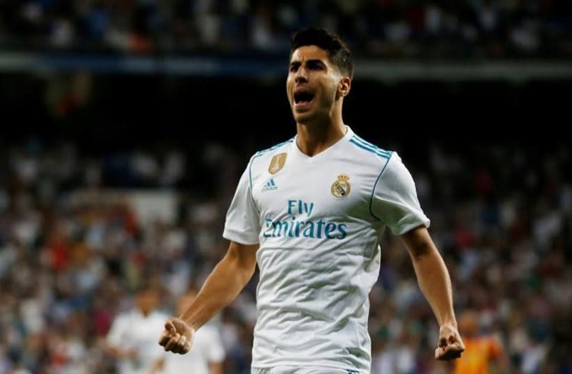 Marco Asensio celebrates a goal. (photo credit: REUTERS/JAVIER BARBANCHO)