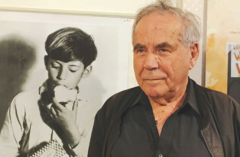 STEF WERTHEIMER stands beside a photo of himself from 81 years ago when he appeared in a margarine advertisement. (The Open Museum Tefen)  (photo credit: Courtesy)