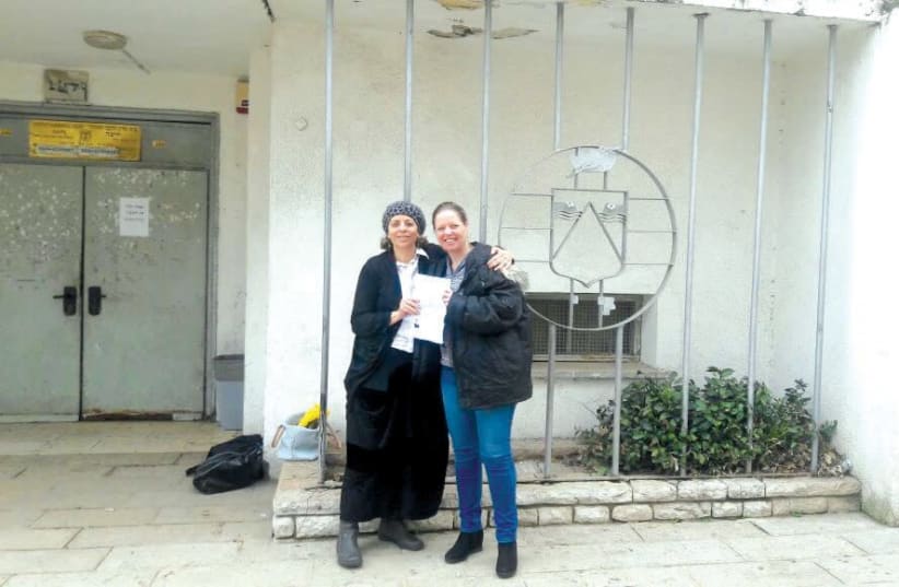 A FORMER ‘chained’ woman (left) stands in front of a rabbinic court with her lawyer after winning her case. (photo credit: Courtesy)