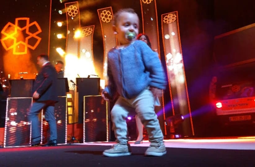 Two year old Elchanan dancing on stage    (photo credit: UNITED HATZALAH‏)
