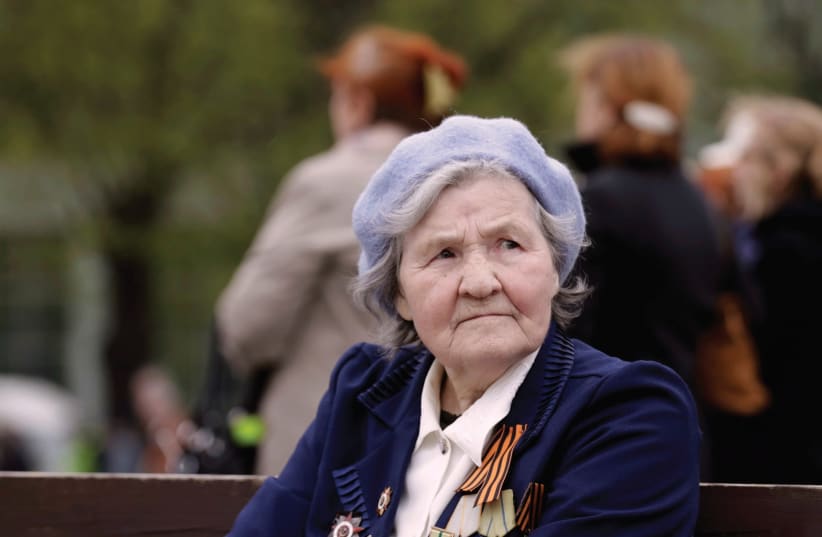 A WOMAN wears her medals during Victory Day celebrations in Riga, Latvia, in 2014, celebrating the victory of the Soviet Union’s Red Army over Nazi Germany in World War II. (photo credit: REUTERS/INTS KALNINS)