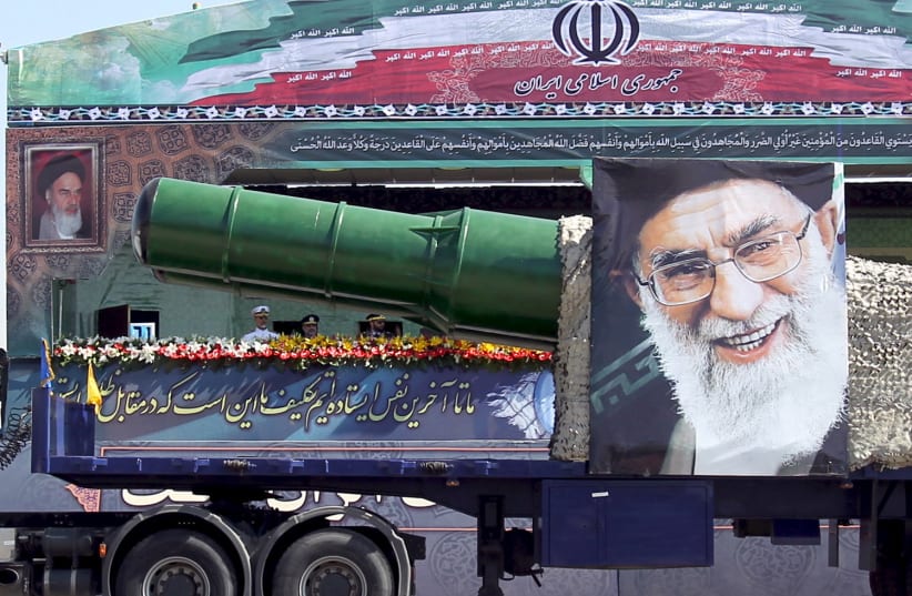 A military truck carrying a missile and a picture of Iran's Supreme Leader Ayatollah Ali Khamenei i (photo credit: REUTERS)