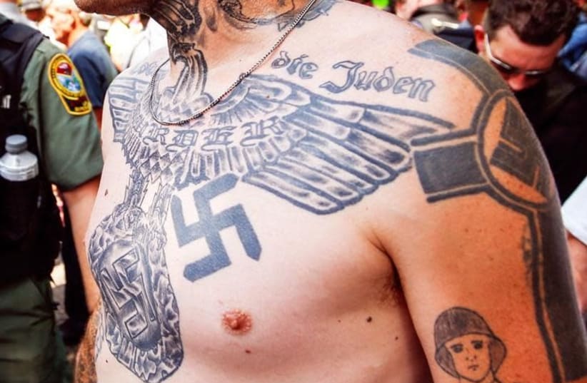 A supporter of the Ku Klux Klan is seen with his tattoos during a rally at the statehouse in Columbia, South Carolina July 18, 2015. (photo credit: REUTERS/CHRIS KEANE)