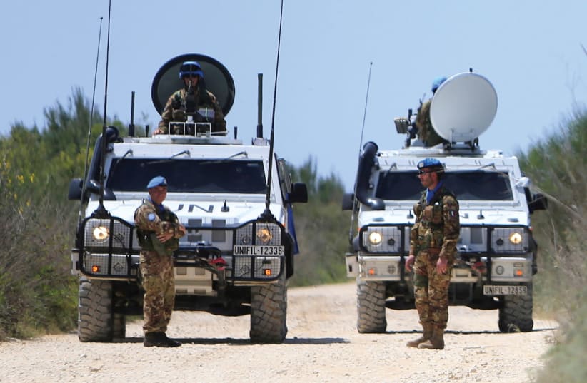 UN Peacekeepers of the United Nations Interim Force in Lebanon (UNIFIL) stand near their vehicles in the Lebanese village of Labbouneh near the Lebanese-Israeli border, earlier this year. (photo credit: REUTERS)