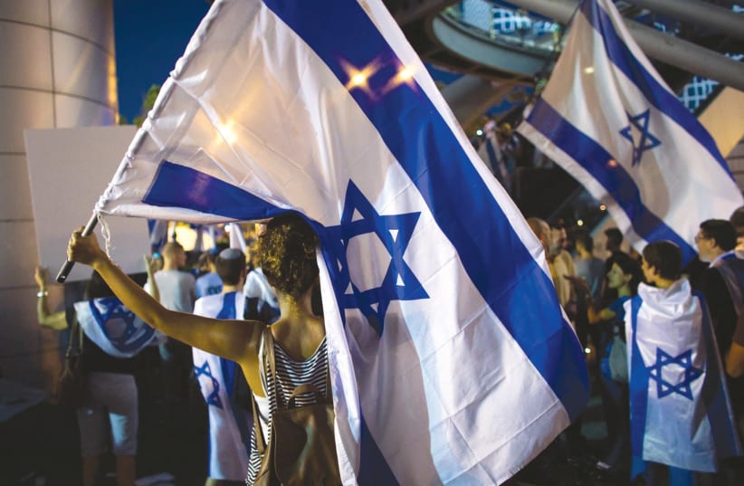 Protestors at a rally in Tel Aviv. The author argues that protesting at politicians’ homes is unethical. (photo credit: REUTERS)