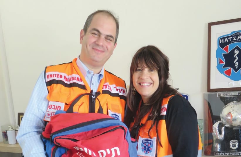 ELI AND GITTY BEER, with matching United Hatzalah vests, are both trained medics (photo credit: JUDY SIEGEL-ITZKOVICH)