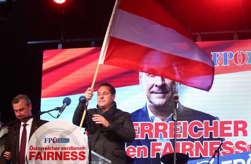 Norbert Hofer (L) and Austrian Freedom Party (FPOe) top candidate Heinz-Christian Strache attend their party's final election campaign rally in Vienna, Austria, October 13, 2017.  (photo credit: MICHAEL DALDER/REUTERS)