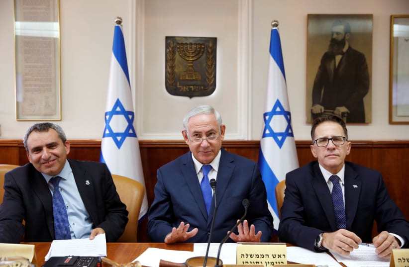 Israeli Prime Minister Benjamin Netanyahu (C), Minister of Environmental Protection Ze'ev Elkin (L) and Cabinet Secretary Tzachi Braverman (R) attend the weekly cabinet meeting in Jerusalem. (photo credit: REUTERS)
